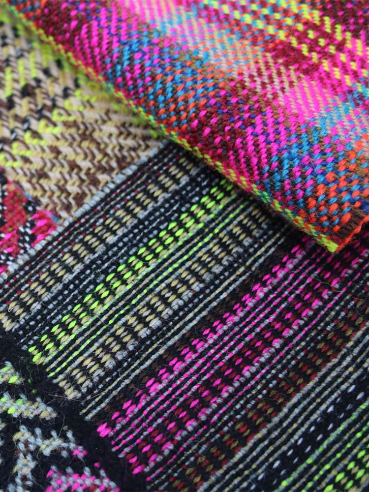 A vibrant fabric with a pattern, seen up close.