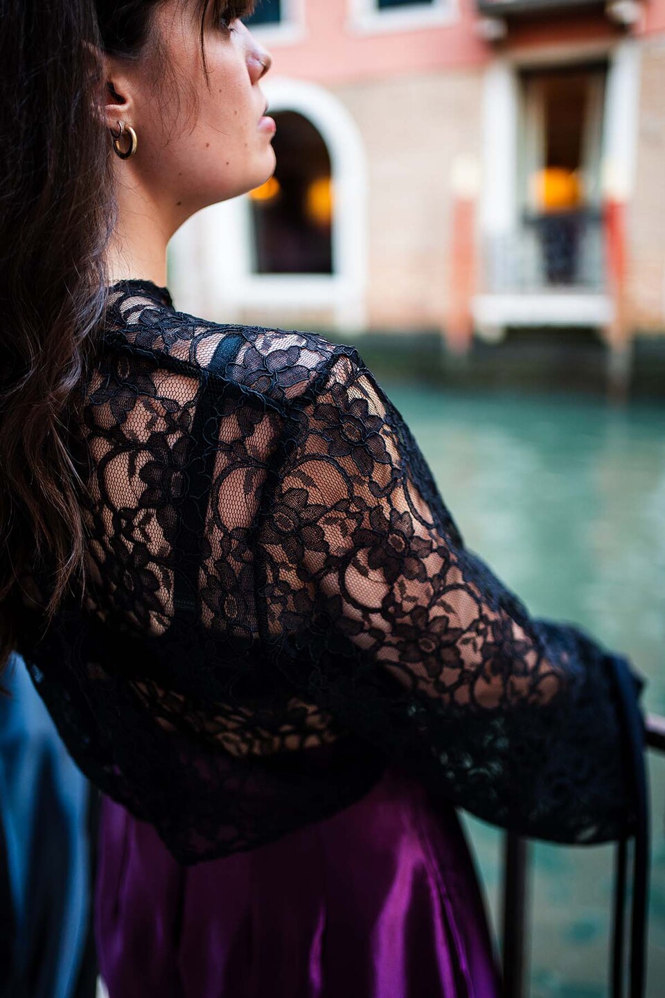 Close up of shoulder and sleeve of a top worn by a woman modelling Flamenco inspired streetwear from a collection by Paula Pacheco by a canal in Seville