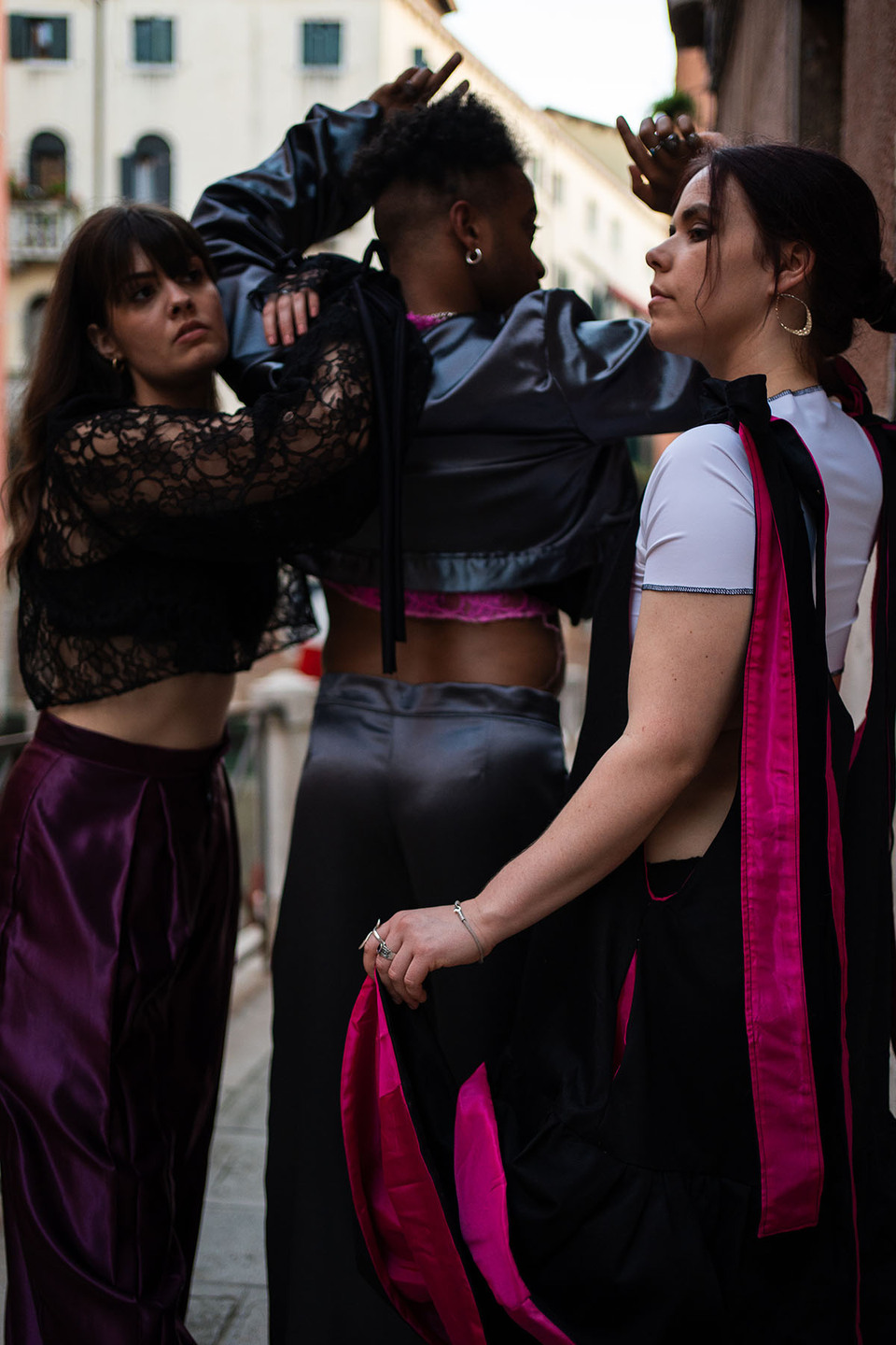 A man and two women modelling Flamenco inspired streetwear from a collection by Paula Pacheco beside the canal in Seville