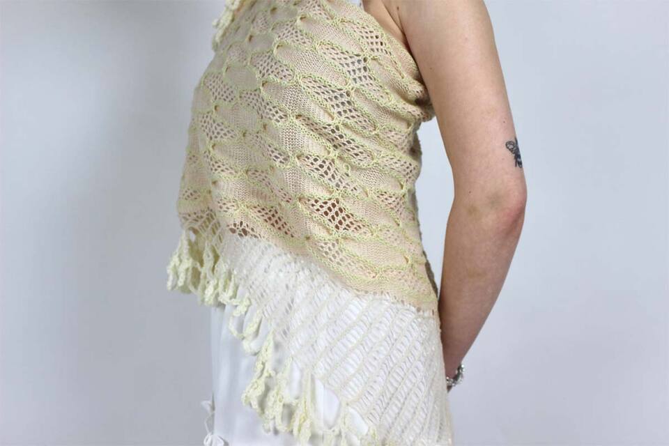 Woman wearing a woven white ivory fringed top