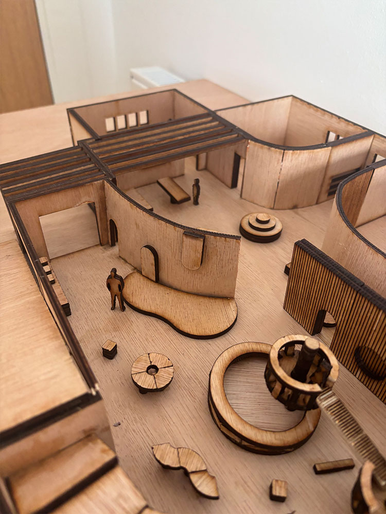 Wooden scale model of interior space showing the layout of rooms.
