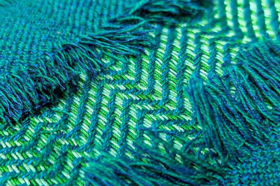 close up of a vibrant green and blue blanket.