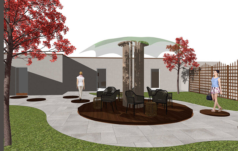 A serene courtyard with a tree and chairs, providing a peaceful outdoor space for relaxation and gatherings.